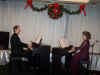 Bruce and Nancy provide Christmas music on 2 pianos for the Pro-Meta Christmas dinner